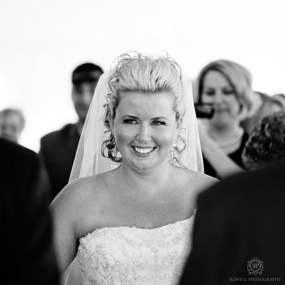 Bride sees her groom at the front of the isle for the first time at Grace and Speed in Muskoka