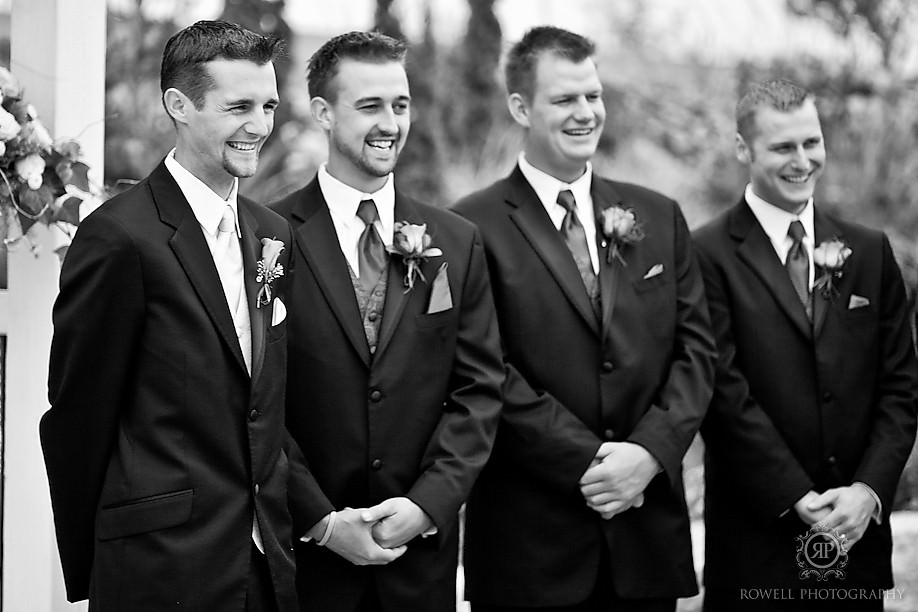 doug the groom watches his bride walk up the isle