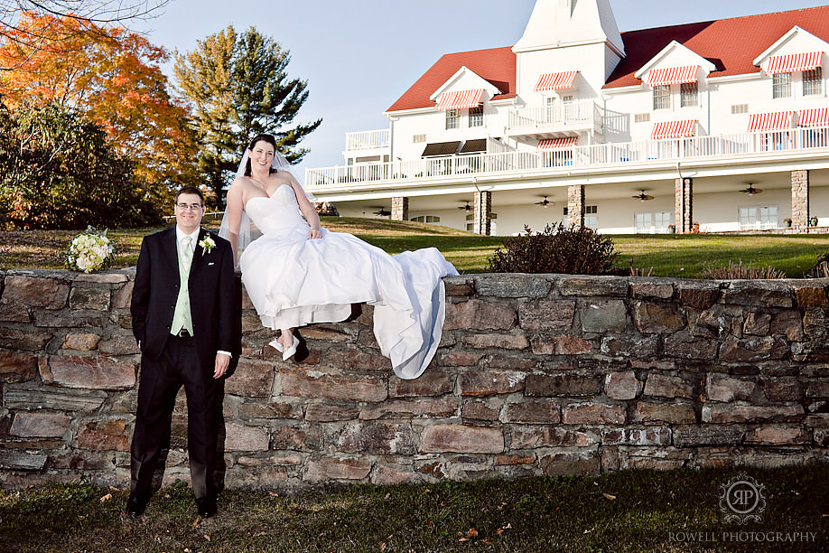 bride and groom infront of winderemere house on brick wall