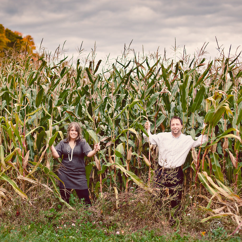 couple standing in corn field engagement photo session