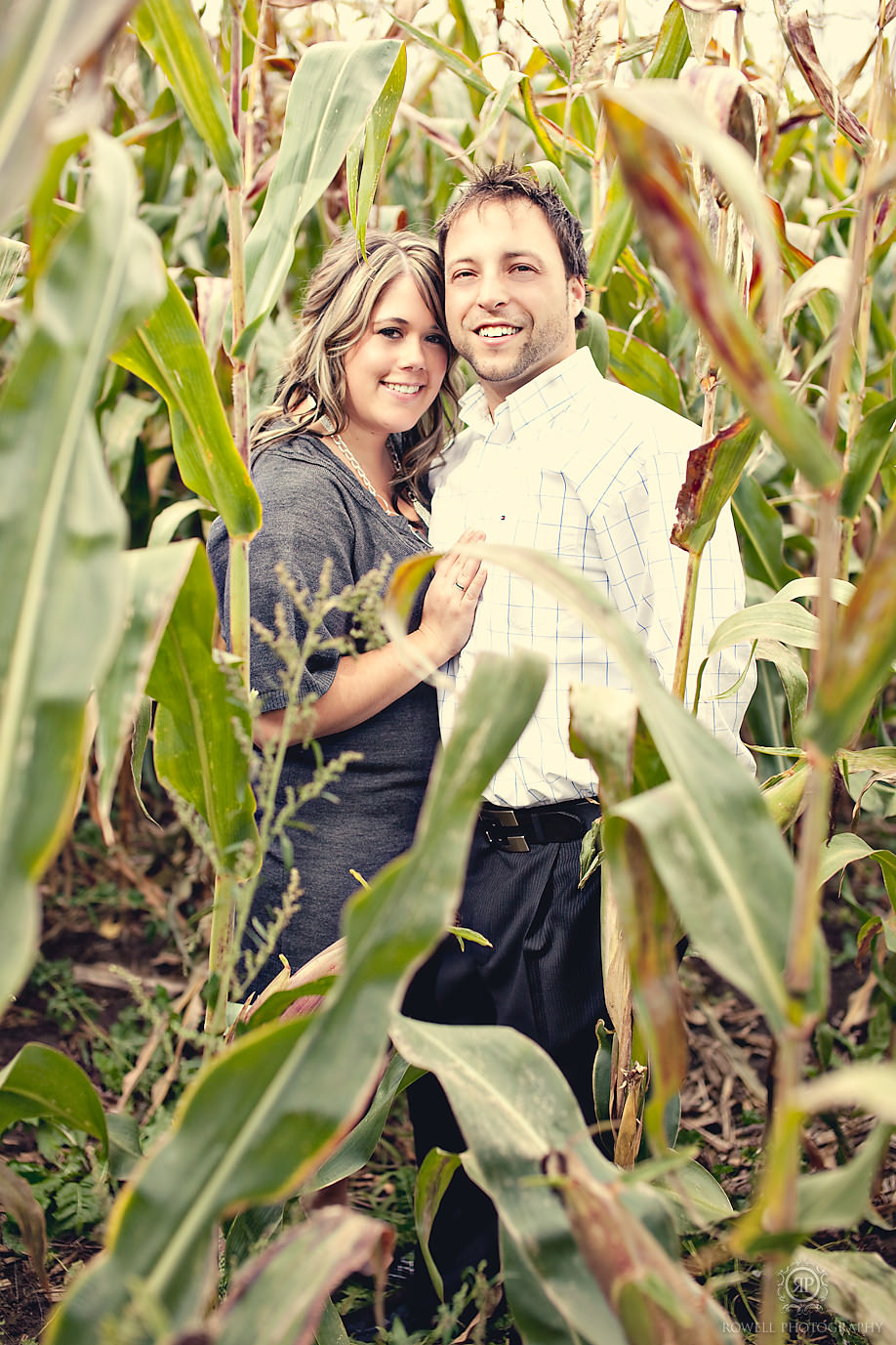 engagement photos in corn field, couple hugging