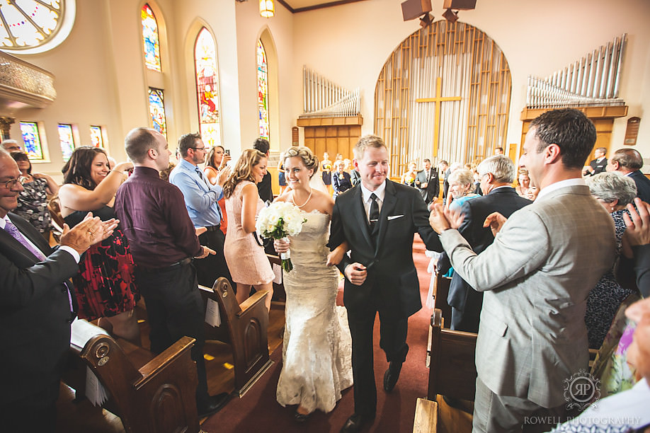 bride and groom walking the isle at collier street united church barrie