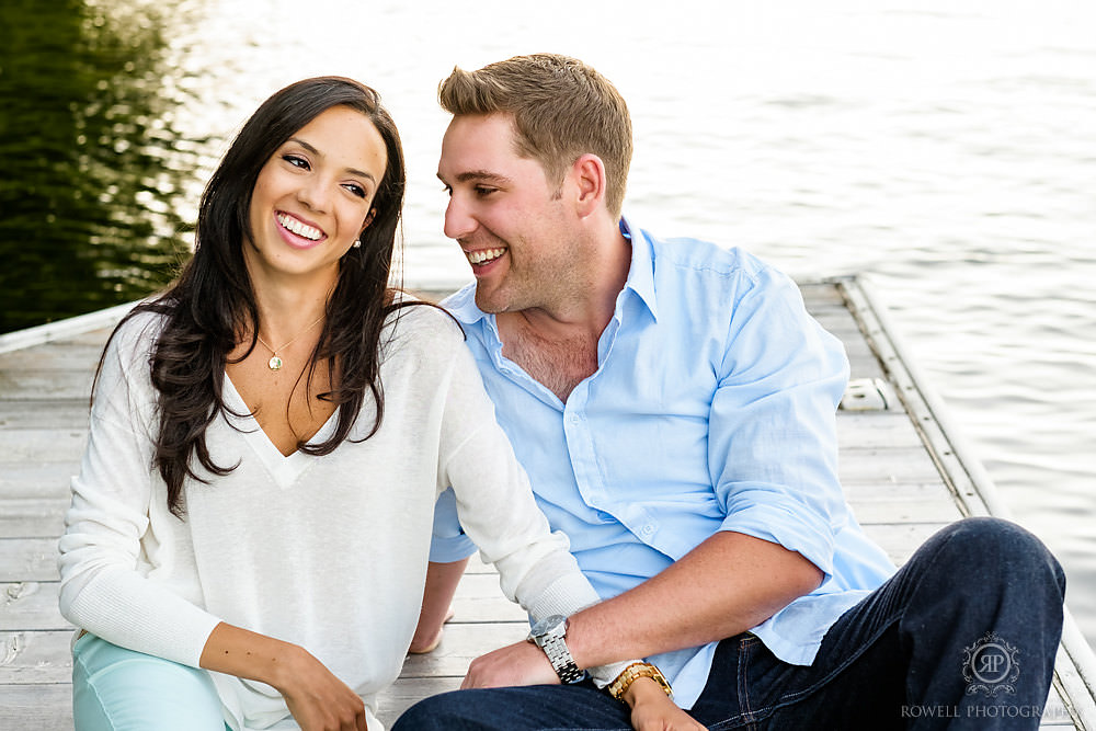 Muskoka photographer captures candid photos during a Muskoka engagement photo shoot on the dock.