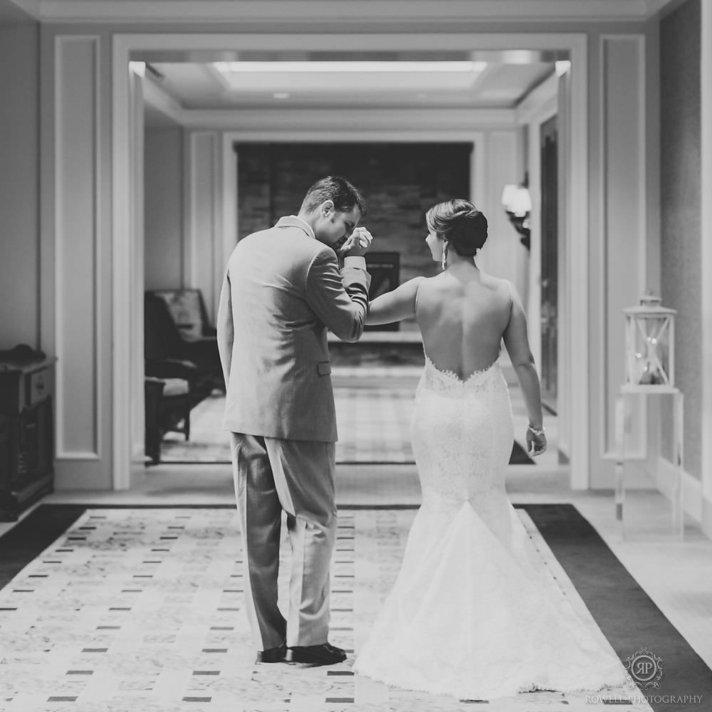 Muskoka wedding photographer captures an intimate moment of the bride and groom as they enter their reception.