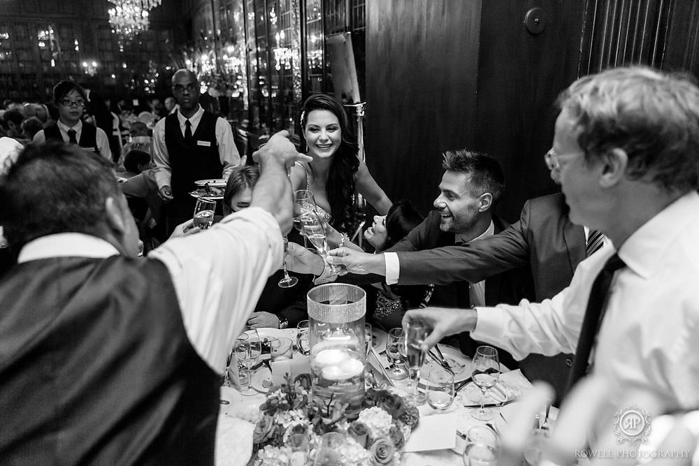 bride cheers glasses at casa loma wedding reception