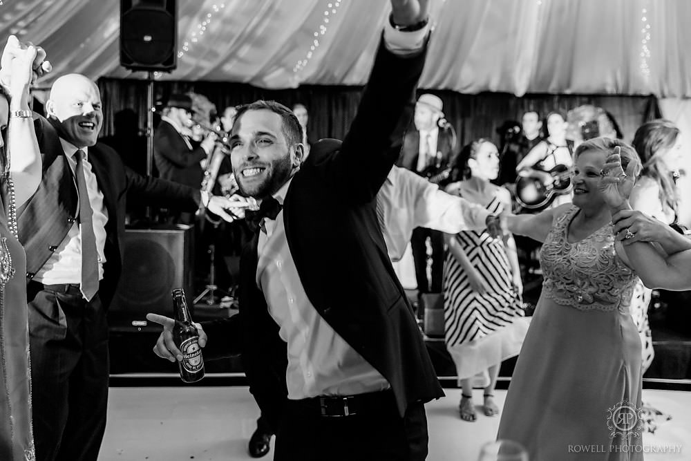 a romantic backyard wedding groom ripping up dancefloor