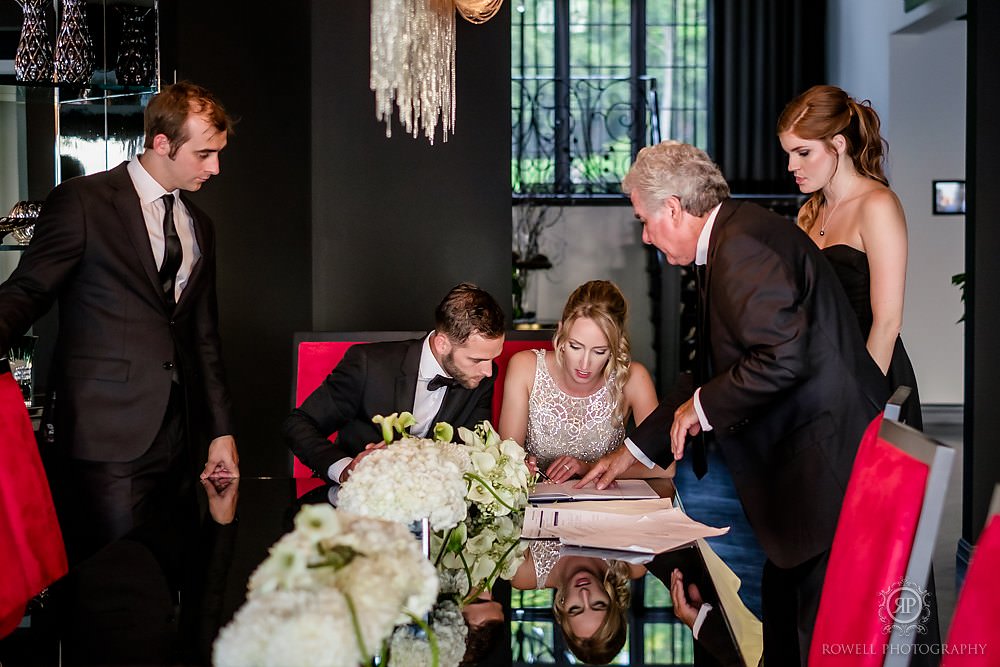 a romantic backyard wedding signing the marriage license